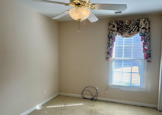 carpeted spare room with ceiling fan