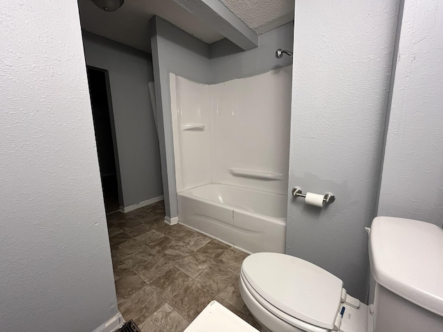 bathroom featuring shower / tub combination and toilet