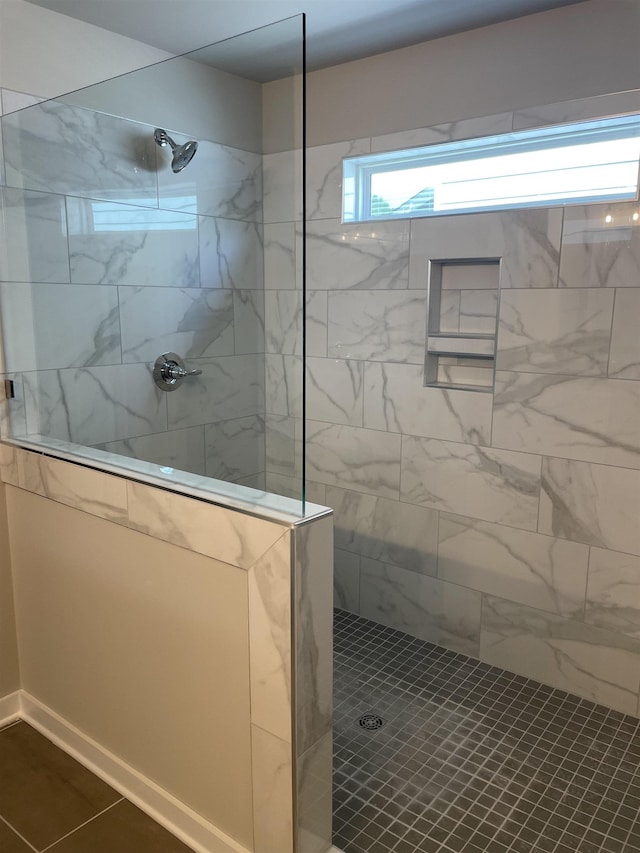 bathroom with tiled shower