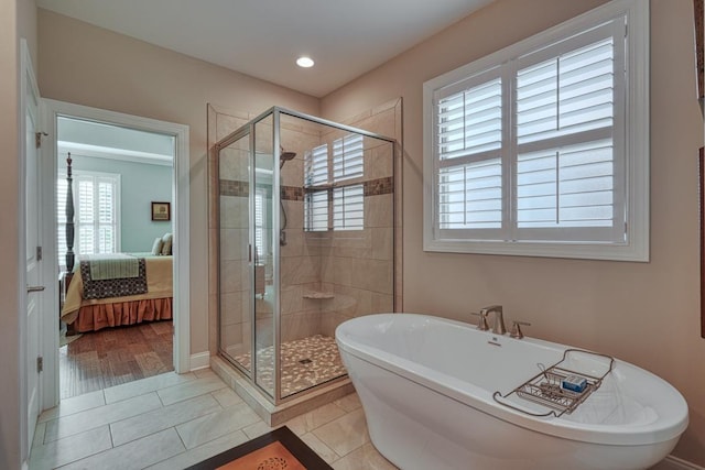 bathroom with independent shower and bath and tile patterned flooring