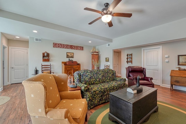 living room with hardwood / wood-style flooring and ceiling fan