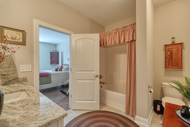 bathroom with shower / bathtub combination with curtain, vanity, vaulted ceiling, and tile patterned floors