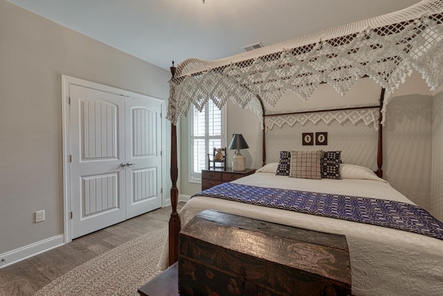 bedroom with wood-type flooring and a closet