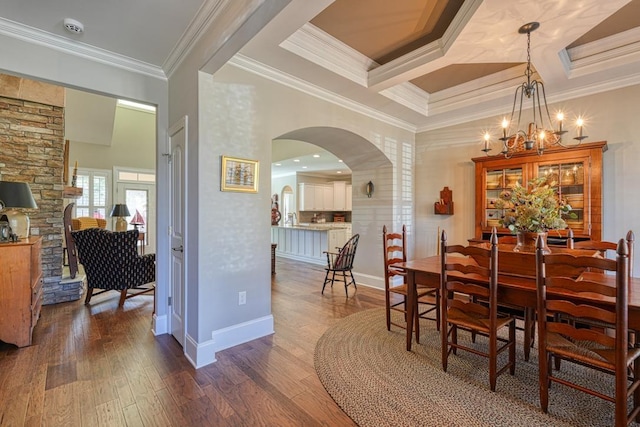 dining room featuring coffered ceiling, crown molding, a chandelier, dark hardwood / wood-style floors, and beam ceiling