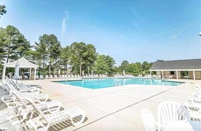 view of swimming pool featuring a gazebo