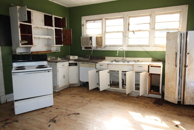 kitchen with white cabinetry, sink, white appliances, and light hardwood / wood-style floors