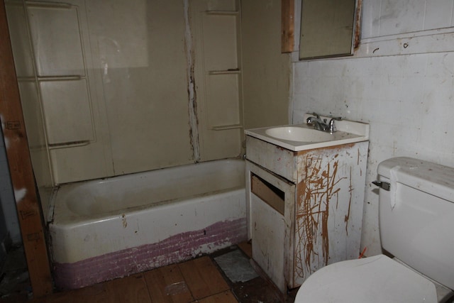 bathroom featuring vanity, wood-type flooring, a bath, and toilet