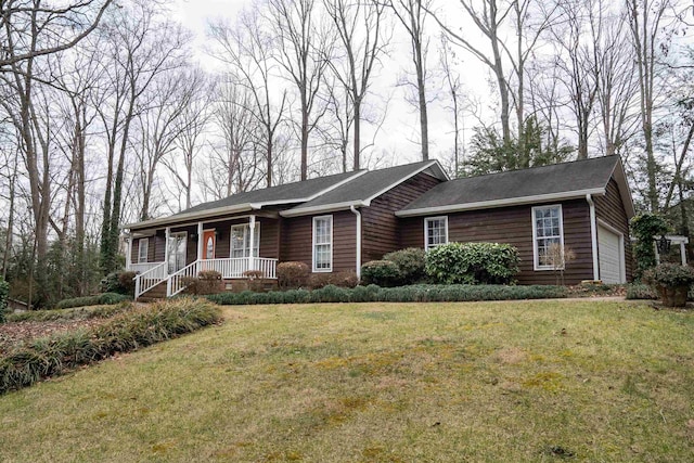 ranch-style house featuring a garage, a front yard, and covered porch