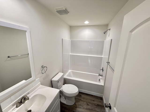 full bathroom featuring wood-type flooring, toilet, tub / shower combination, and vanity