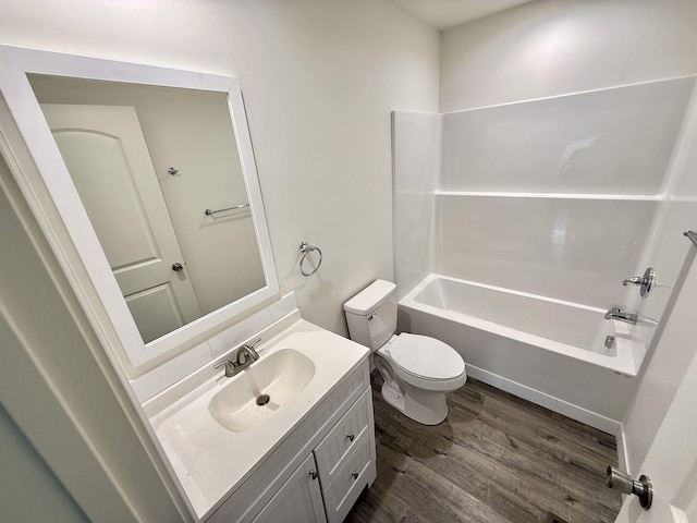 full bathroom with hardwood / wood-style flooring, shower / tub combination, vanity, and toilet