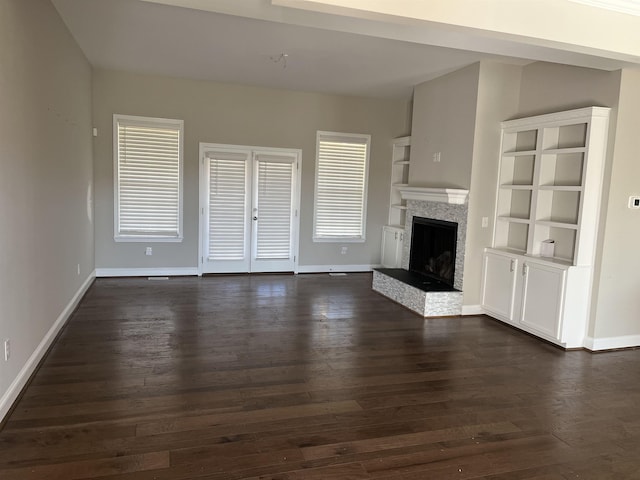 unfurnished living room with dark wood-type flooring and french doors