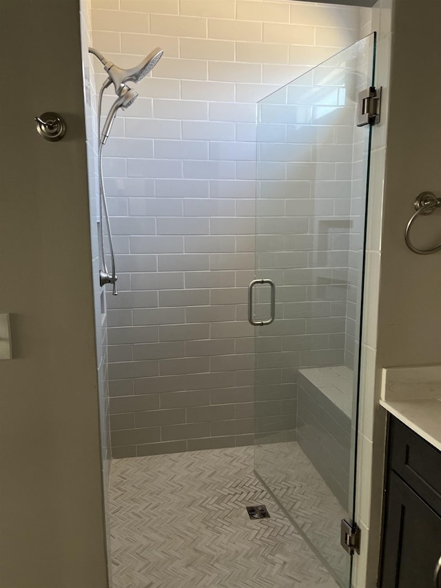 bathroom featuring vanity and a shower with shower door