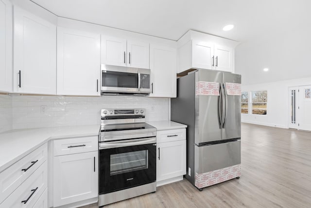 kitchen featuring white cabinetry, appliances with stainless steel finishes, tasteful backsplash, and light wood-type flooring