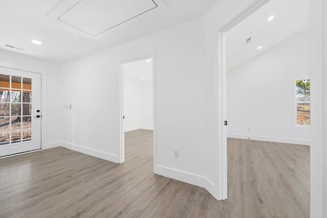 spare room featuring light hardwood / wood-style flooring and a wealth of natural light