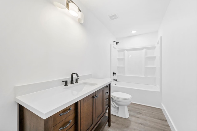 full bathroom featuring vanity, shower / washtub combination, hardwood / wood-style floors, and toilet