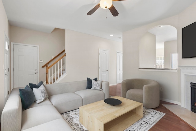 living room featuring ceiling fan and hardwood / wood-style floors