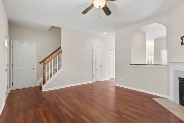 unfurnished living room with dark wood-type flooring and ceiling fan