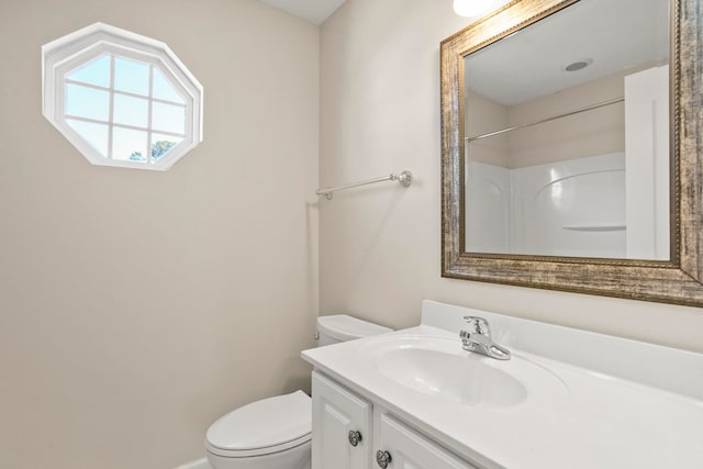 bathroom featuring vanity, toilet, and a shower