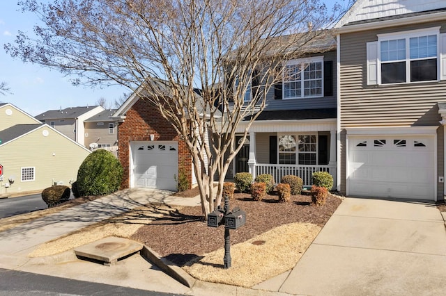 view of property with a garage and covered porch