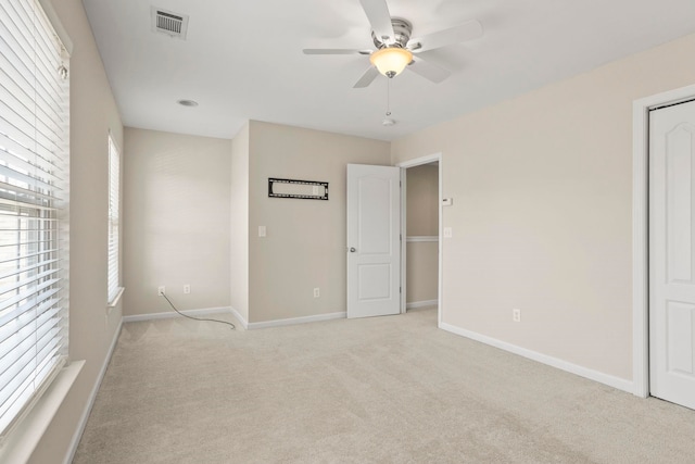 unfurnished bedroom featuring light colored carpet and ceiling fan