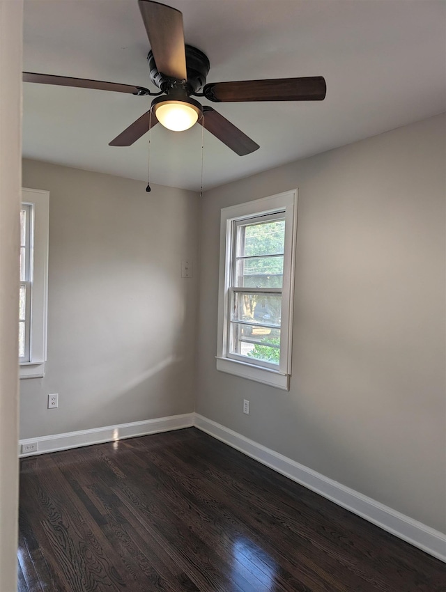 spare room with ceiling fan and dark hardwood / wood-style flooring