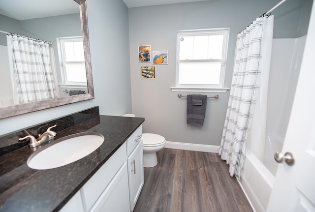 full bathroom with toilet, wood-type flooring, shower / bathtub combination with curtain, and vanity