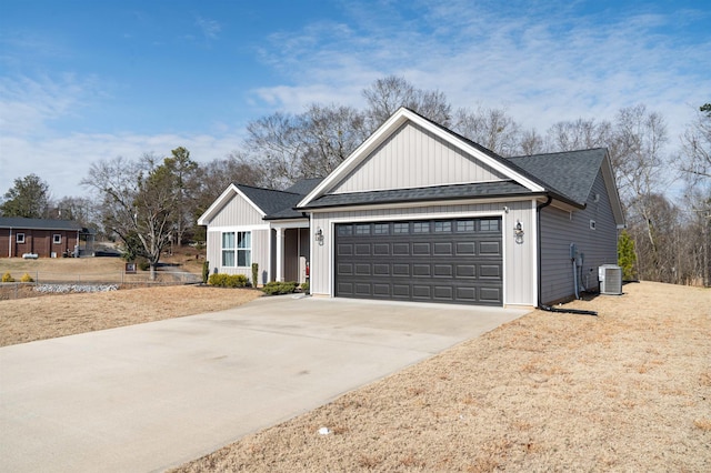 view of front of property featuring a garage and central AC