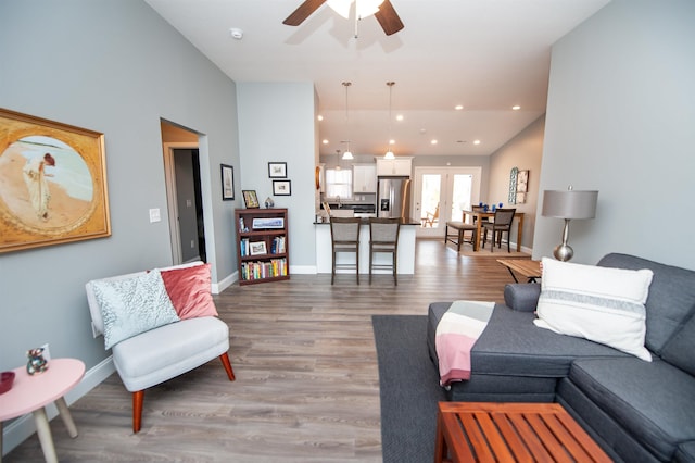 living room with light hardwood / wood-style floors and ceiling fan