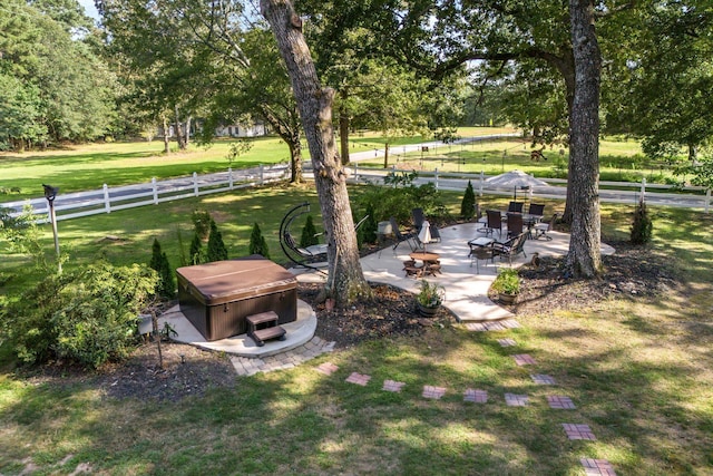 view of yard featuring a hot tub and a patio area