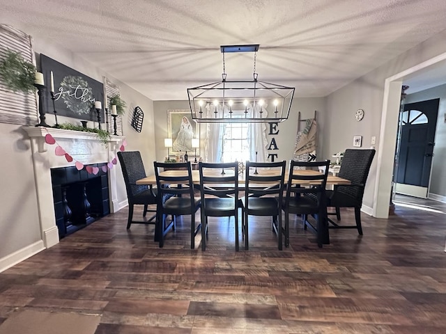 dining room with dark hardwood / wood-style flooring, a chandelier, and a textured ceiling