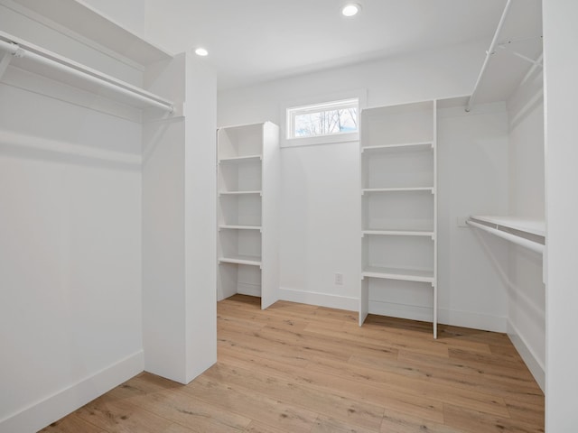 spacious closet with light hardwood / wood-style floors