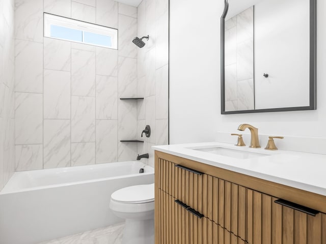 full bathroom featuring tiled shower / bath, vanity, and toilet