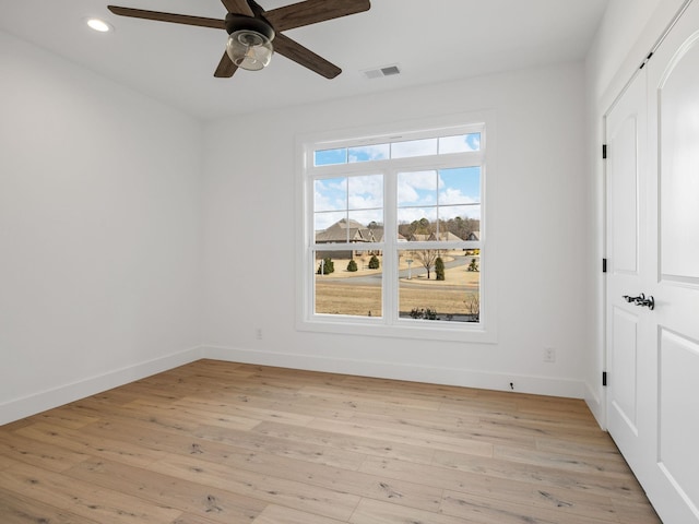 spare room featuring ceiling fan and light wood-type flooring