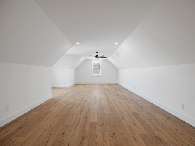 additional living space with ceiling fan, lofted ceiling, and light wood-type flooring