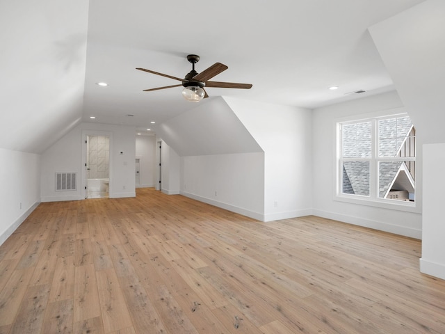 additional living space featuring vaulted ceiling, ceiling fan, and light wood-type flooring