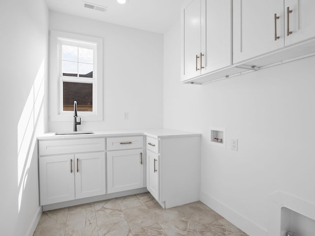 laundry room featuring cabinets, sink, and washer hookup