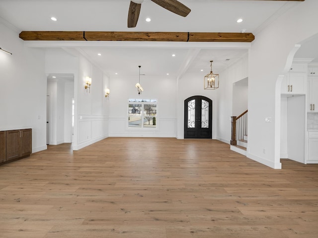 foyer entrance with beamed ceiling, crown molding, and light wood-type flooring