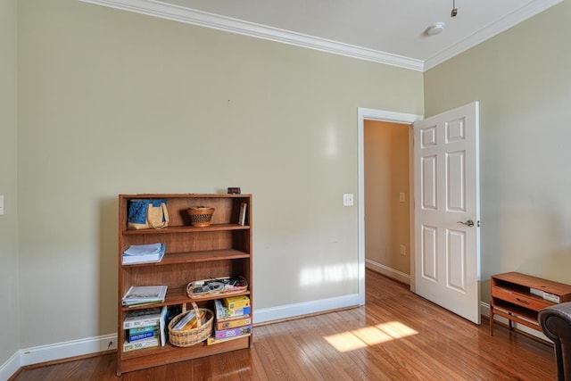 interior space featuring ornamental molding and light hardwood / wood-style floors