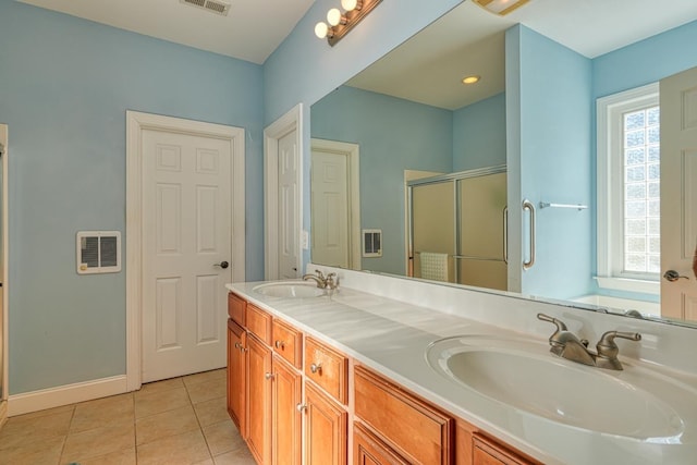 bathroom featuring tile patterned floors, a shower with shower door, and vanity