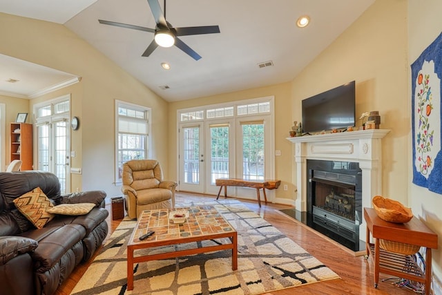 living room featuring vaulted ceiling, ceiling fan, and light wood-type flooring