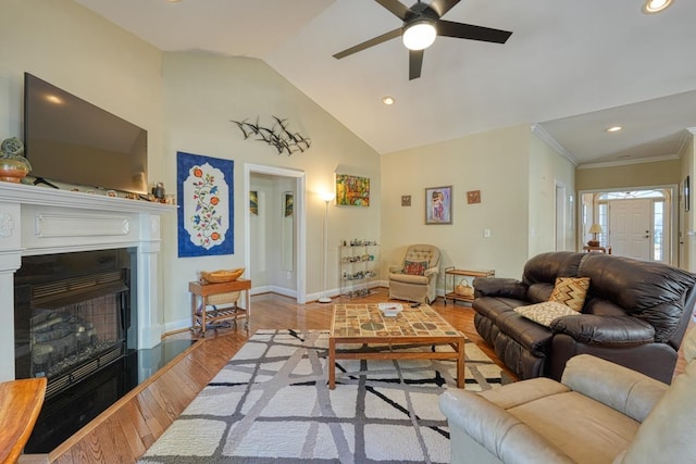 living room with vaulted ceiling, crown molding, ceiling fan, and light hardwood / wood-style floors