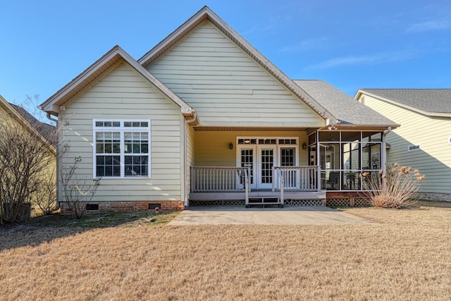 view of front of property with a front yard, french doors, and a sunroom