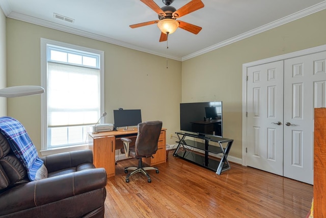 home office with ceiling fan, ornamental molding, and light hardwood / wood-style floors