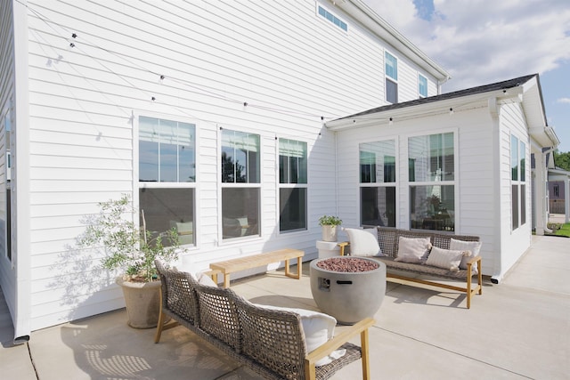 view of patio featuring an outdoor living space with a fire pit