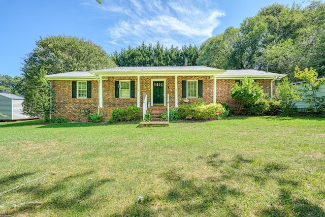 ranch-style home with a front yard and covered porch