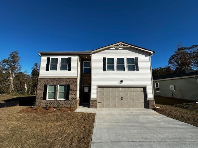 view of front of house with a garage and a front yard