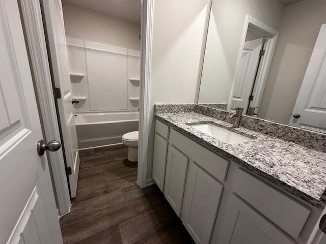 full bathroom with shower / tub combination, vanity, toilet, and hardwood / wood-style floors