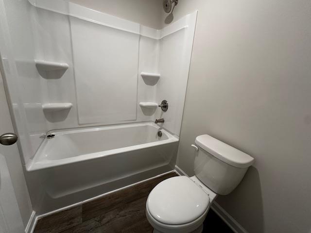 bathroom with shower / bathing tub combination and toilet