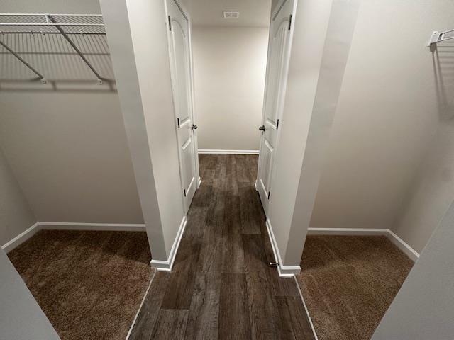 corridor featuring dark hardwood / wood-style flooring