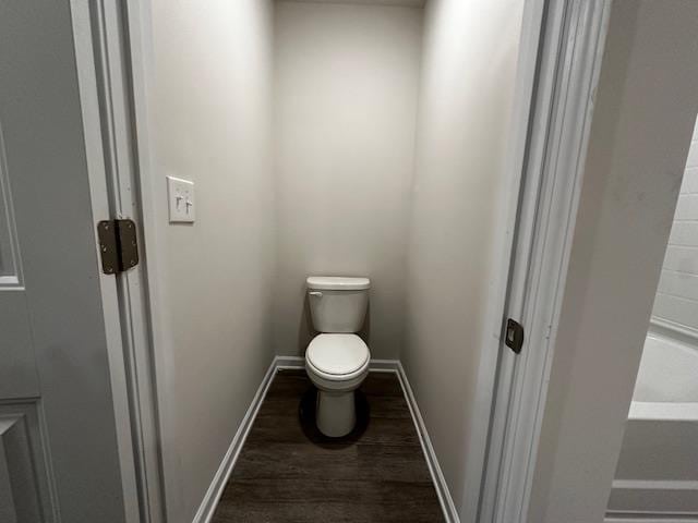 bathroom with wood-type flooring and toilet